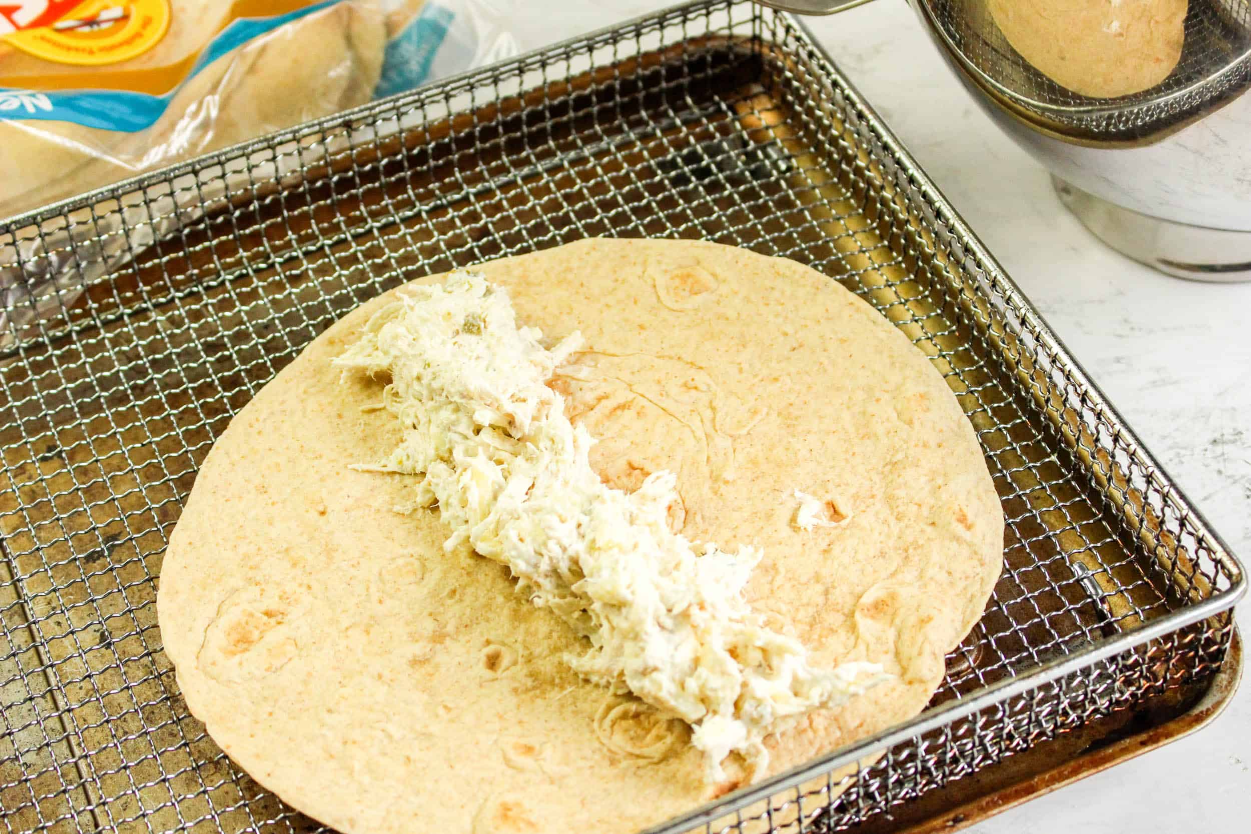 Rolling air fryer chicken jalapeño poppers taquitos up.