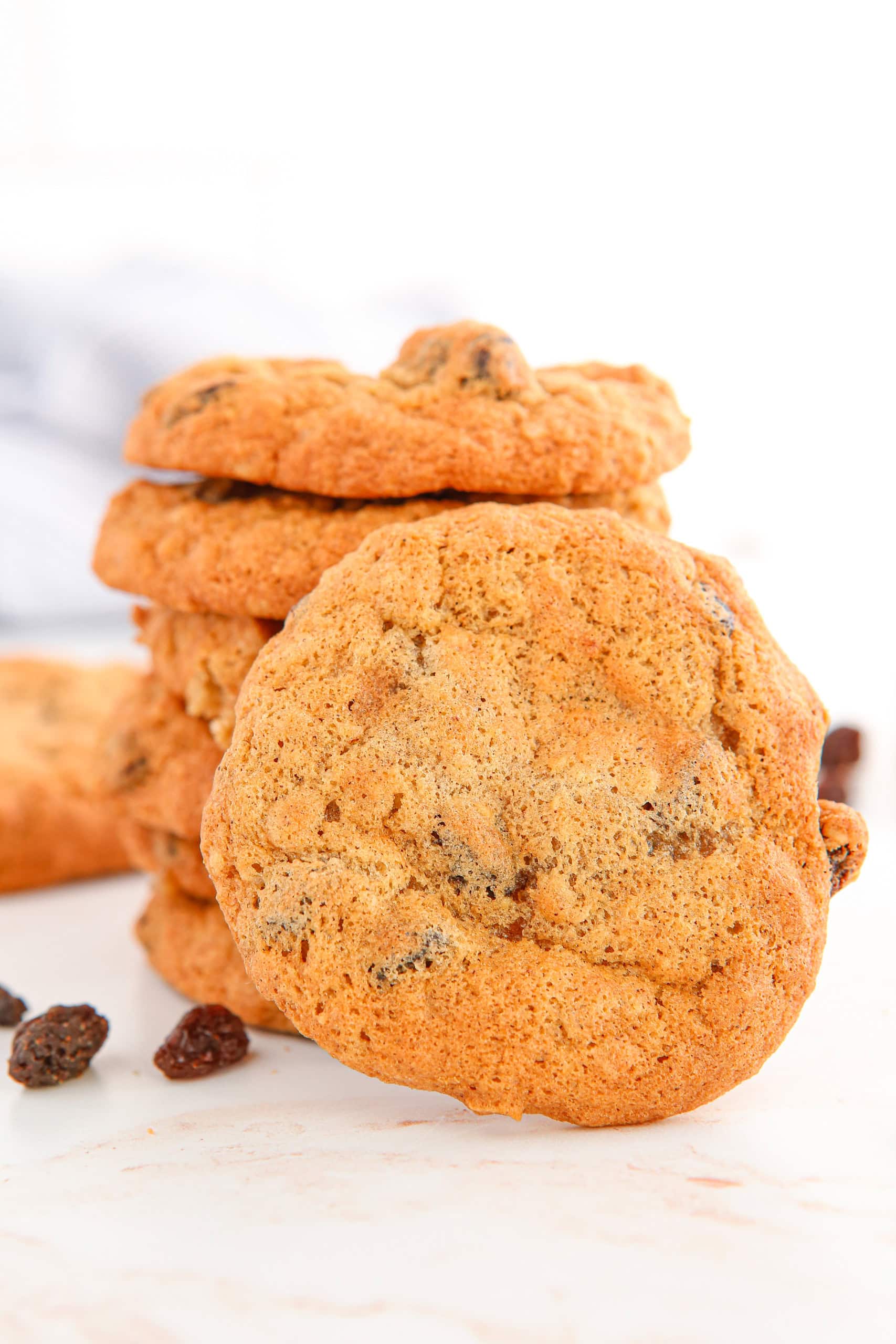 stack of oatmeal raisin cookies with one propped in front.