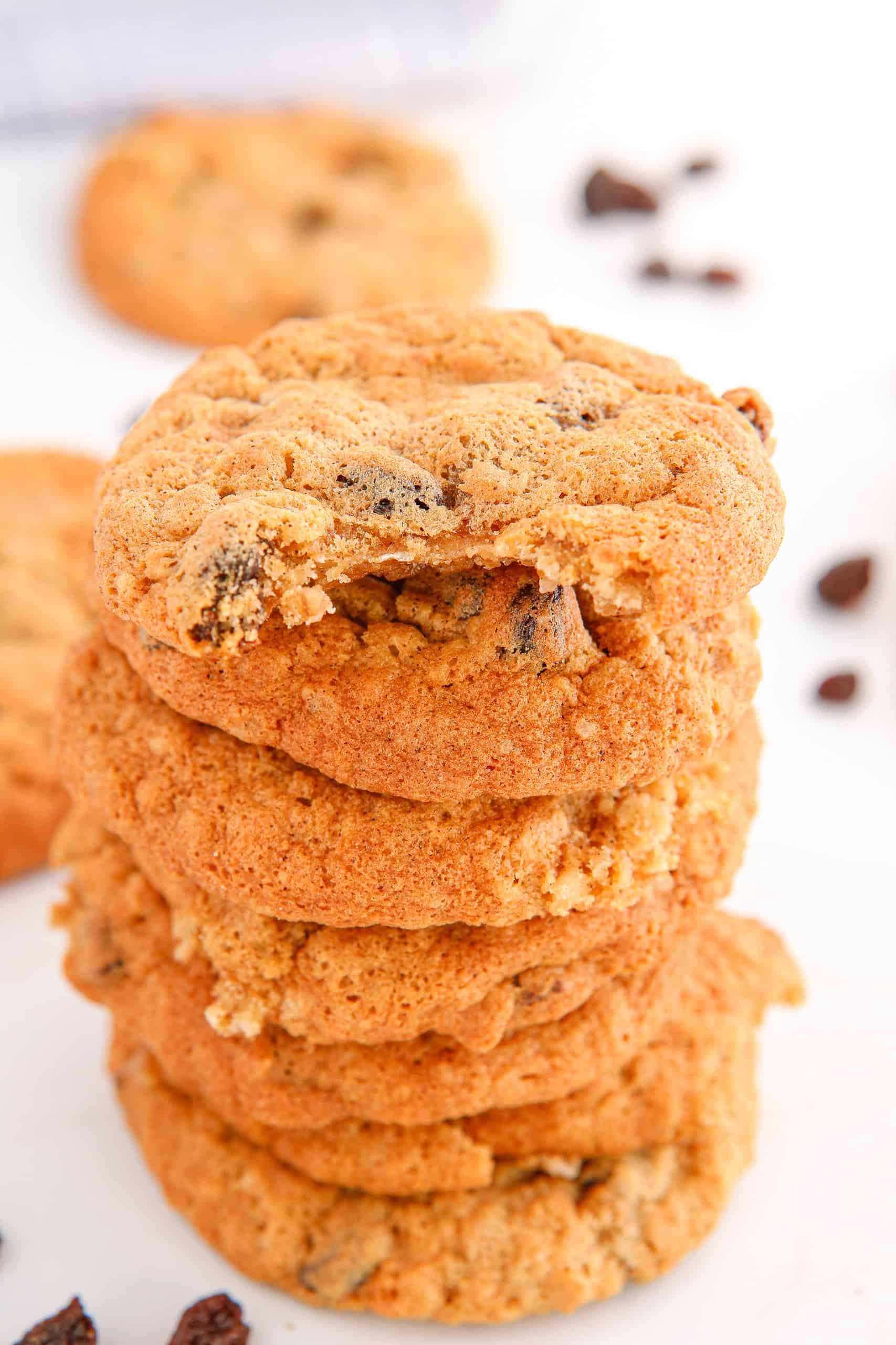 Headon view of stack of oatmeal raisin cookies. Top cookie has a bite out of it.