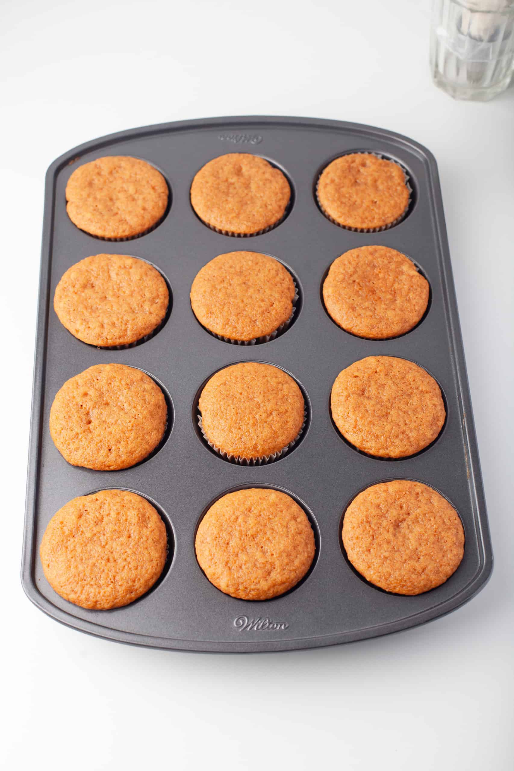 Overhead view of baked pumpkin spice cupcakes.