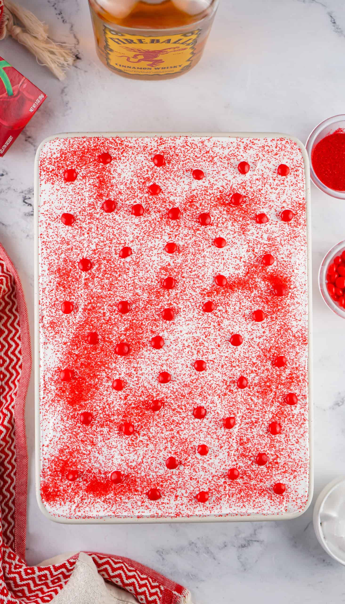 Overhead view of decorated Fireball Poke Cake.