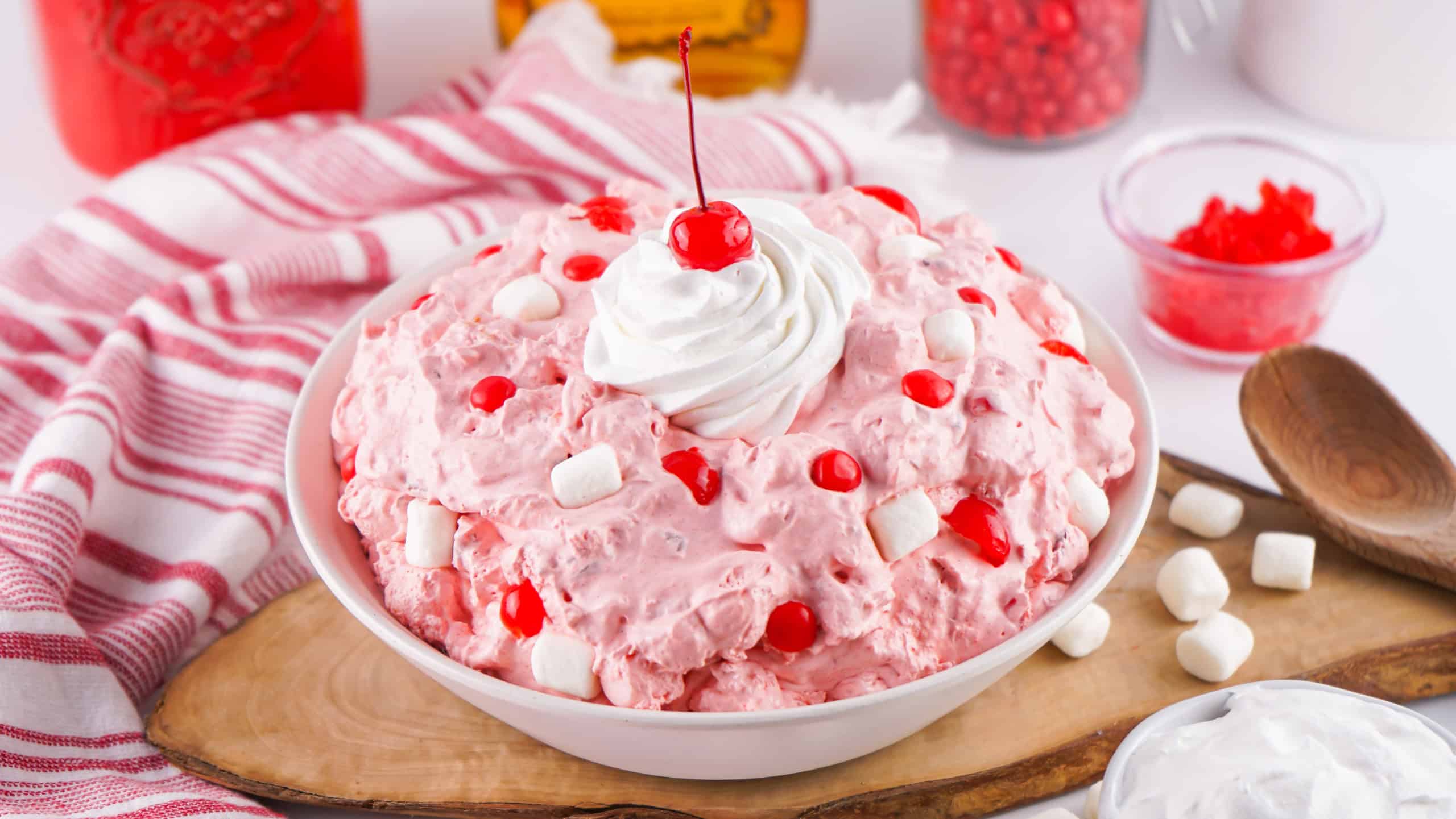 Fireball Fluff Salad with whipped cream and a cherry on top.