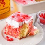 Headon slice of Fireball poke cake with a bite out of it.