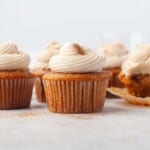 Headon view of pumpkin cupcakes with cream cheese frosting.