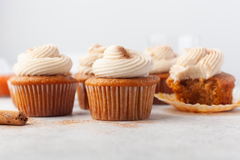 Headon view of pumpkin cupcakes with cream cheese frosting.