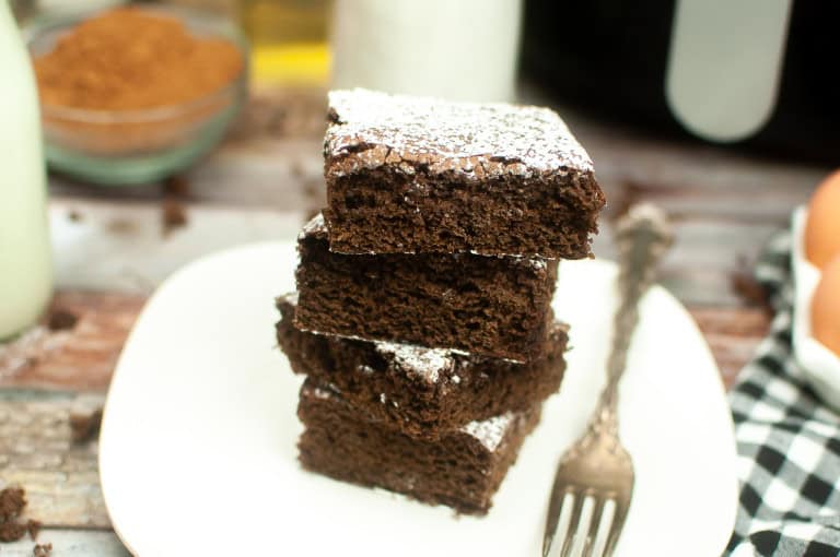 Stack of air fryer brownies on a square white plate.