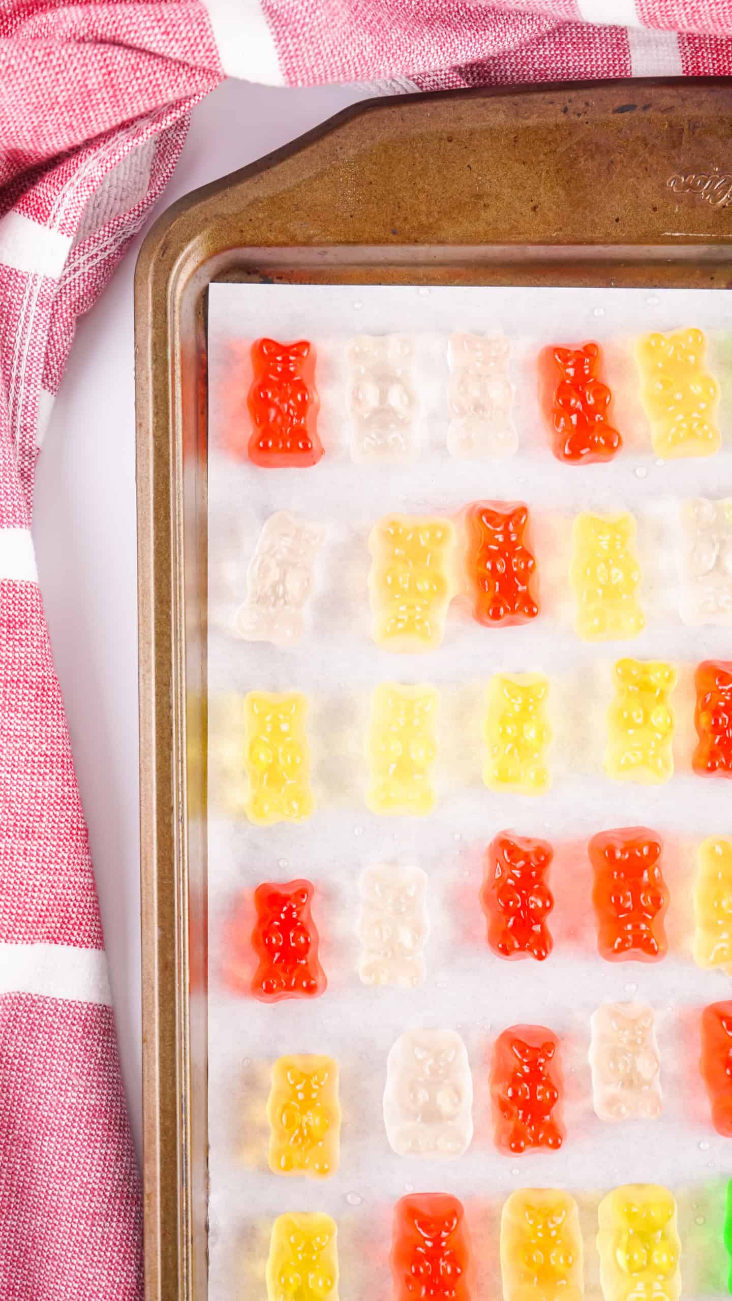 Overhead view of frozen gummy bears on a sheet pan.