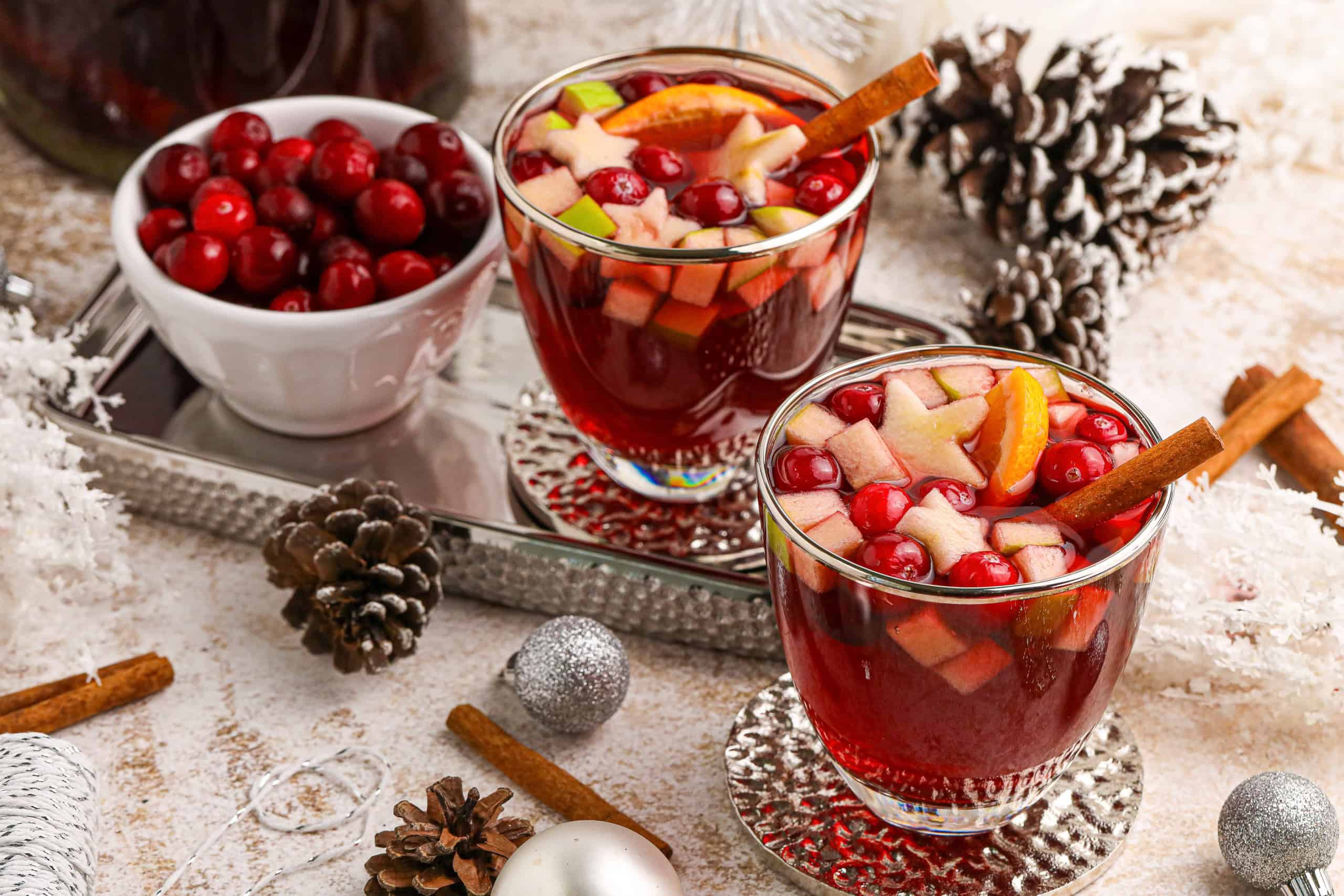 Overhead view of 2 glass mugs filled with holiday sangria cocktail or mocktail.