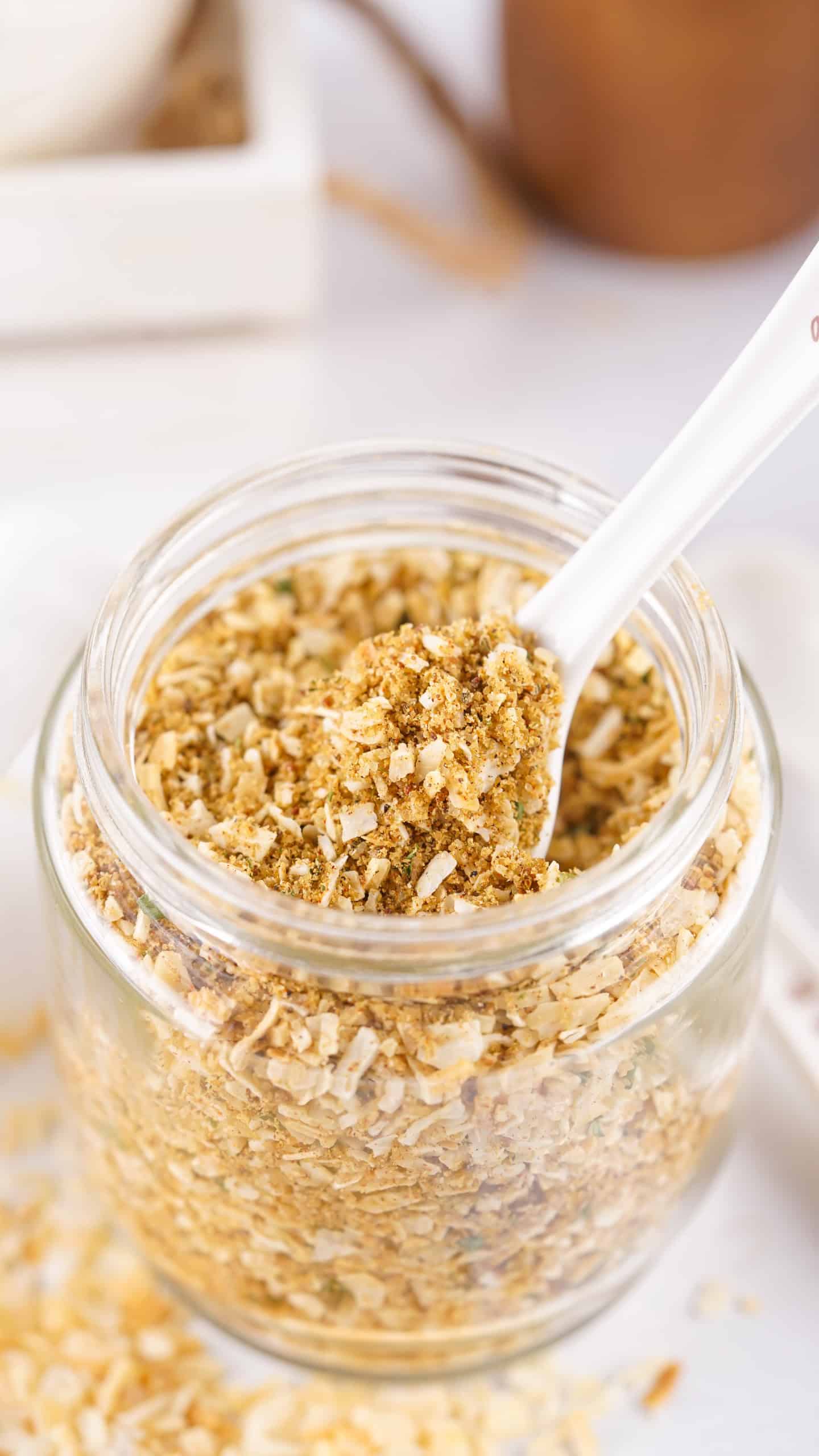 Jar of onion soup mix with a spoon in it.