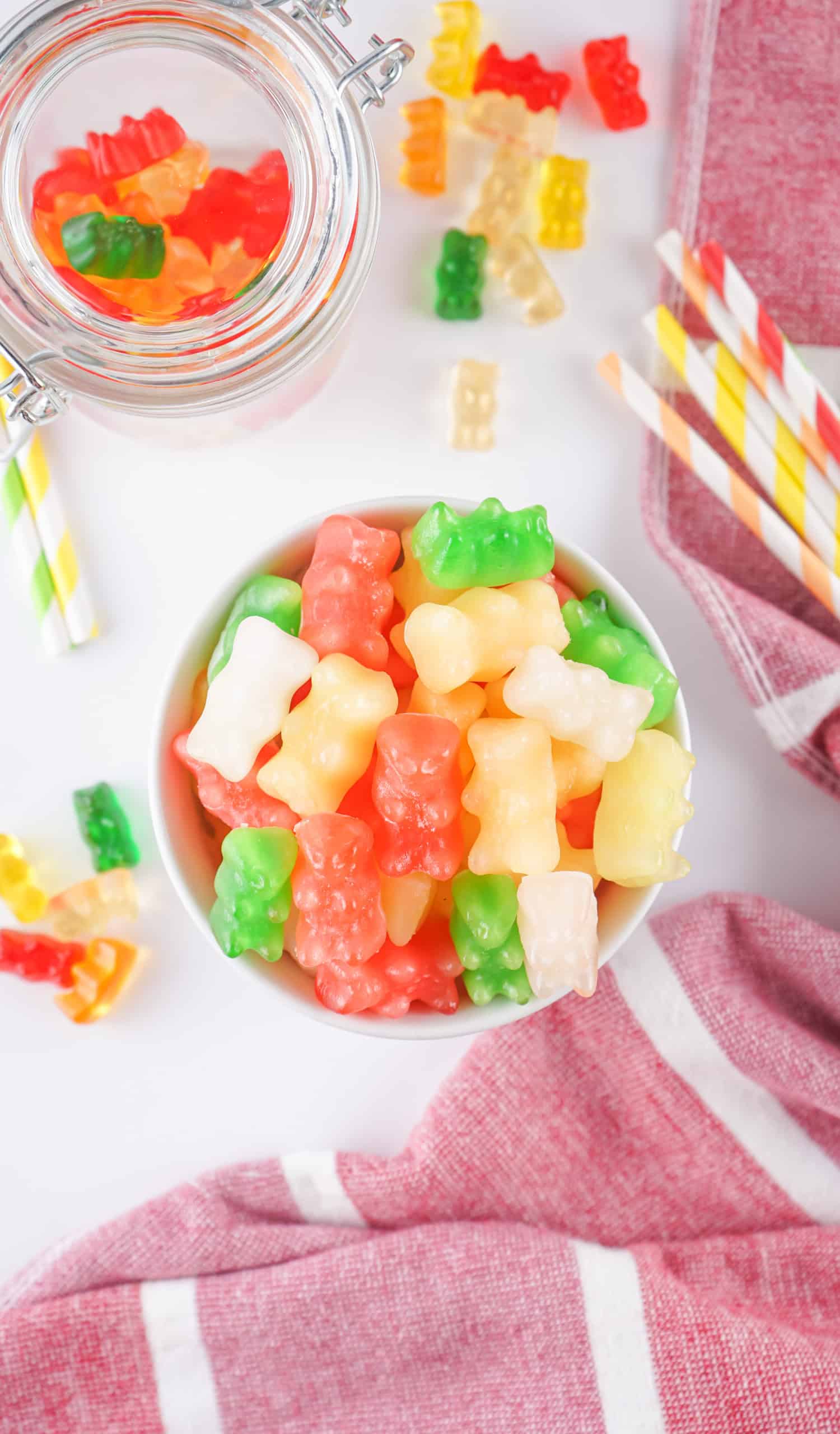 Overhead view of frozen gummy bears in a small white bowl.