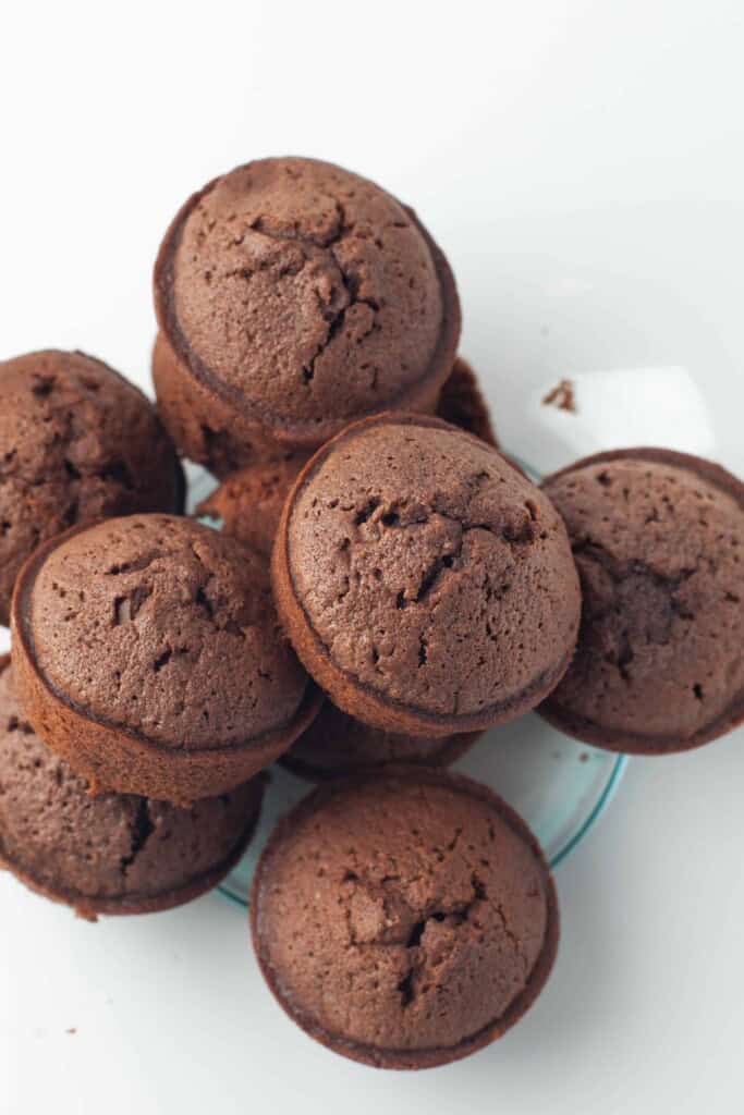 Brownie Bites stacked on a white plate.