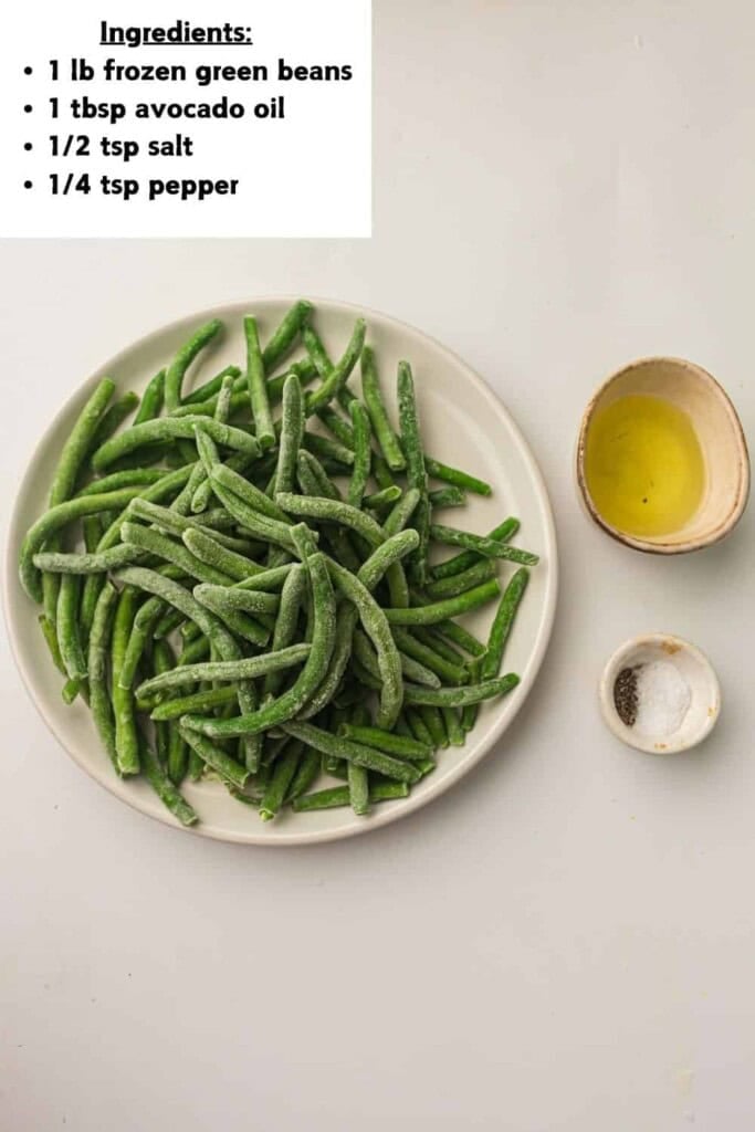 Overhead view of frozen green beans, avocado oil and salt and pepper.