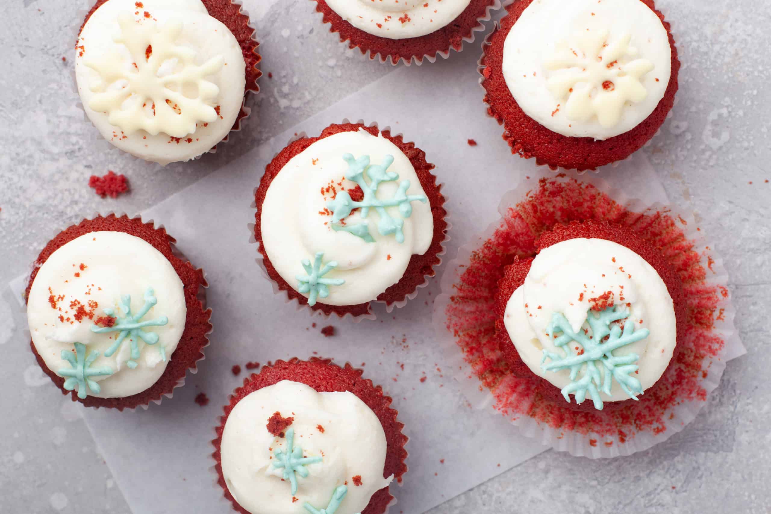 Overhead view of cupcakes with chocolate snowflakes.