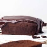 Head on view of chocolate pound cake with chocolate ganache frosting.