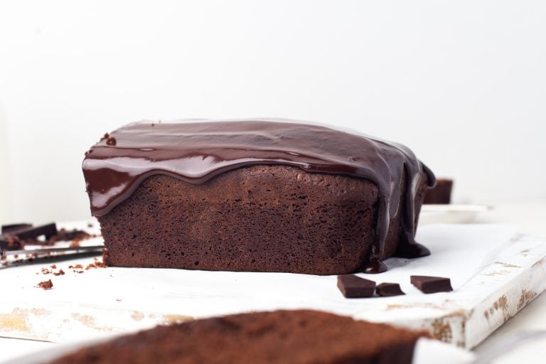 Head on view of chocolate pound cake with chocolate ganache frosting.