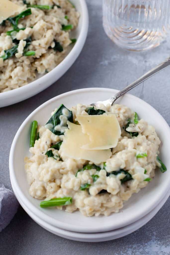 pasta in small white bowl with silver spoon.