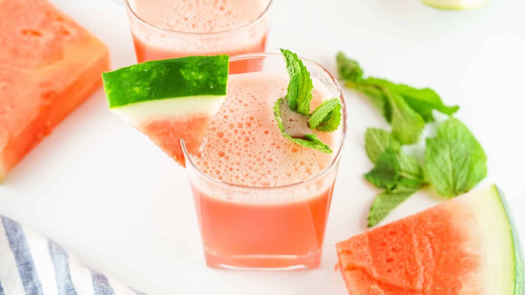 Overhead view of watermelon aqua Fresca with watermelon slice and a sprig of mint.