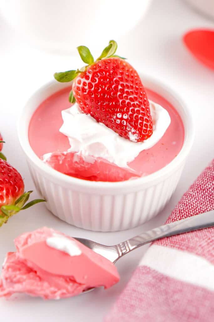Bowl of creamy Greek yogurt protein fluff topped with a fresh strawberry.