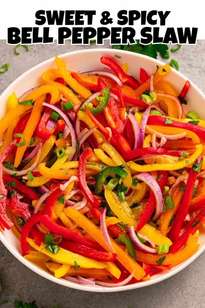 Overhead view Red, Orange, Yellow Bell Pepper Slaw in a white bowl pin.