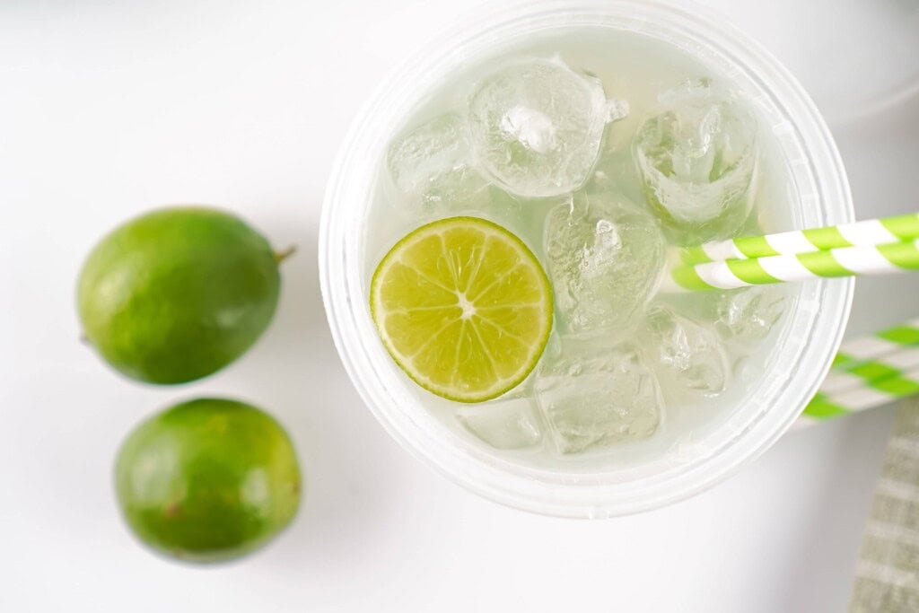 Overhead view of limeade with lime slice in it.
