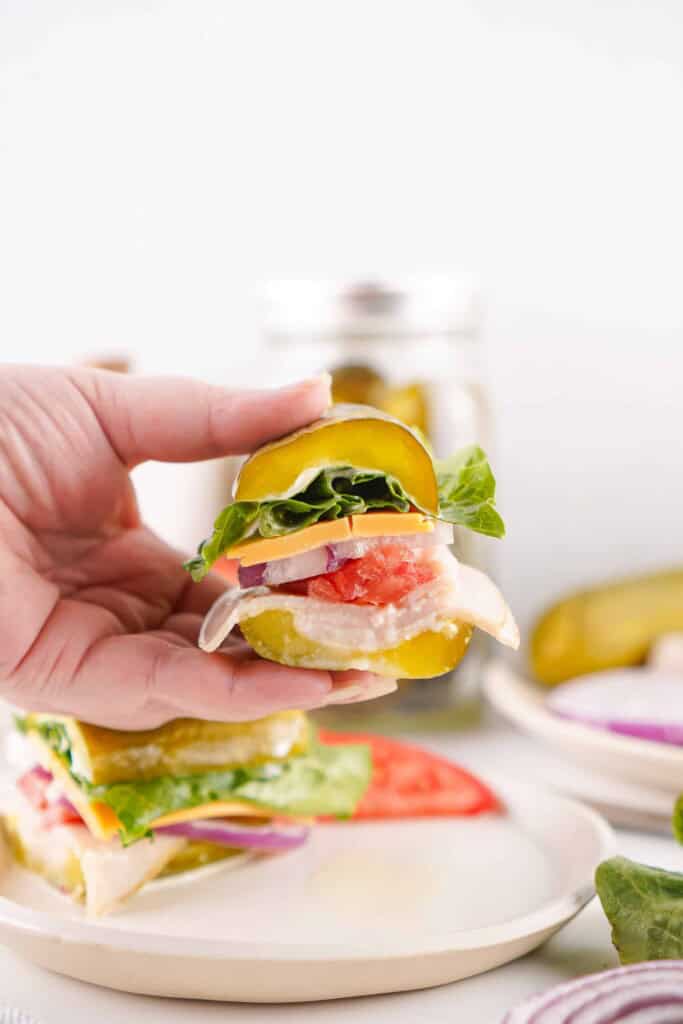 Headon view of pickle sandwich cut in half.