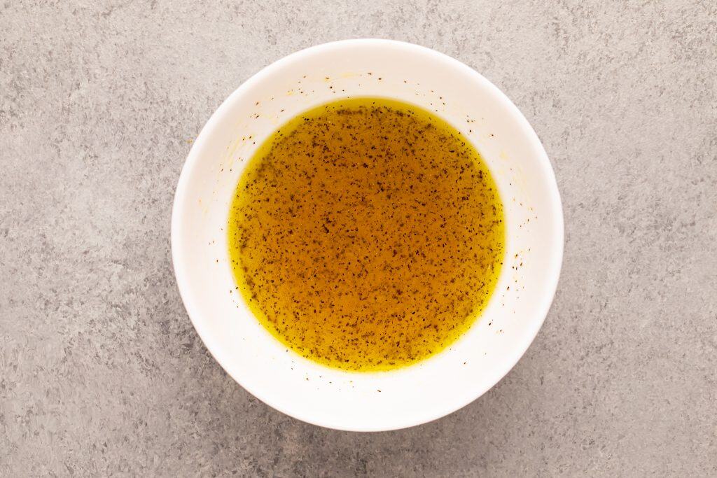 Overhead view of olive oil and vinegar dressing.