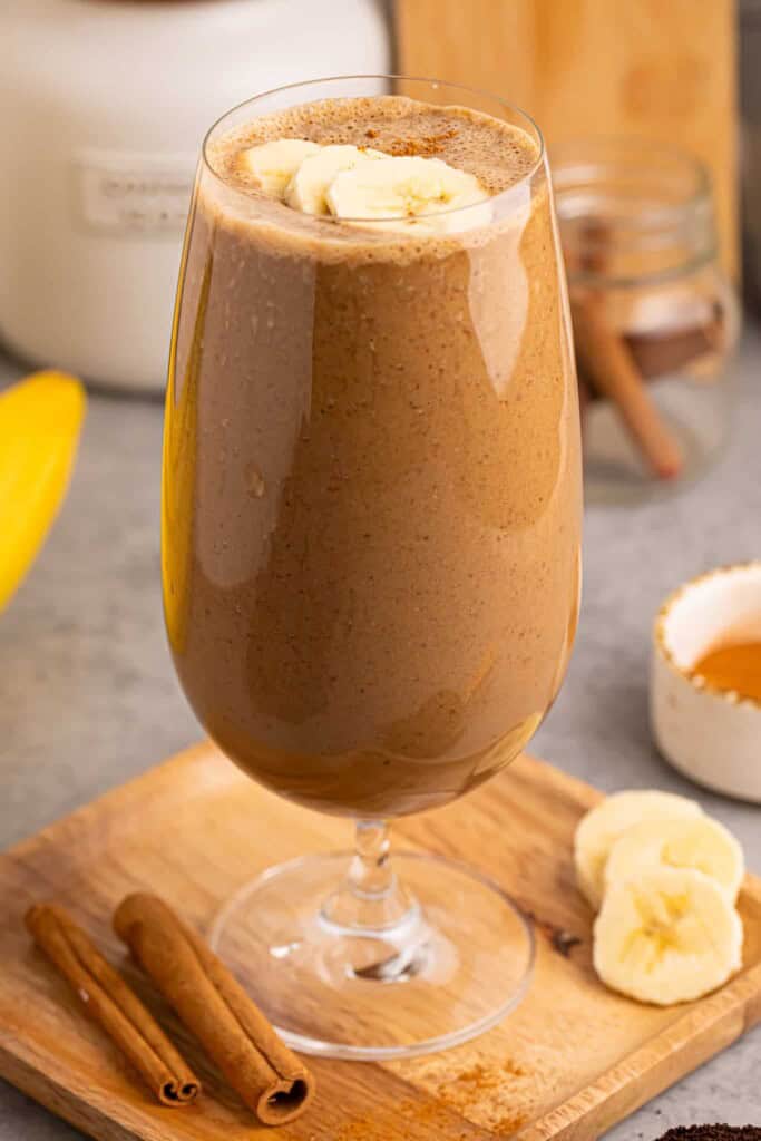 Head-on photo of coffee banana smoothie in a glass.