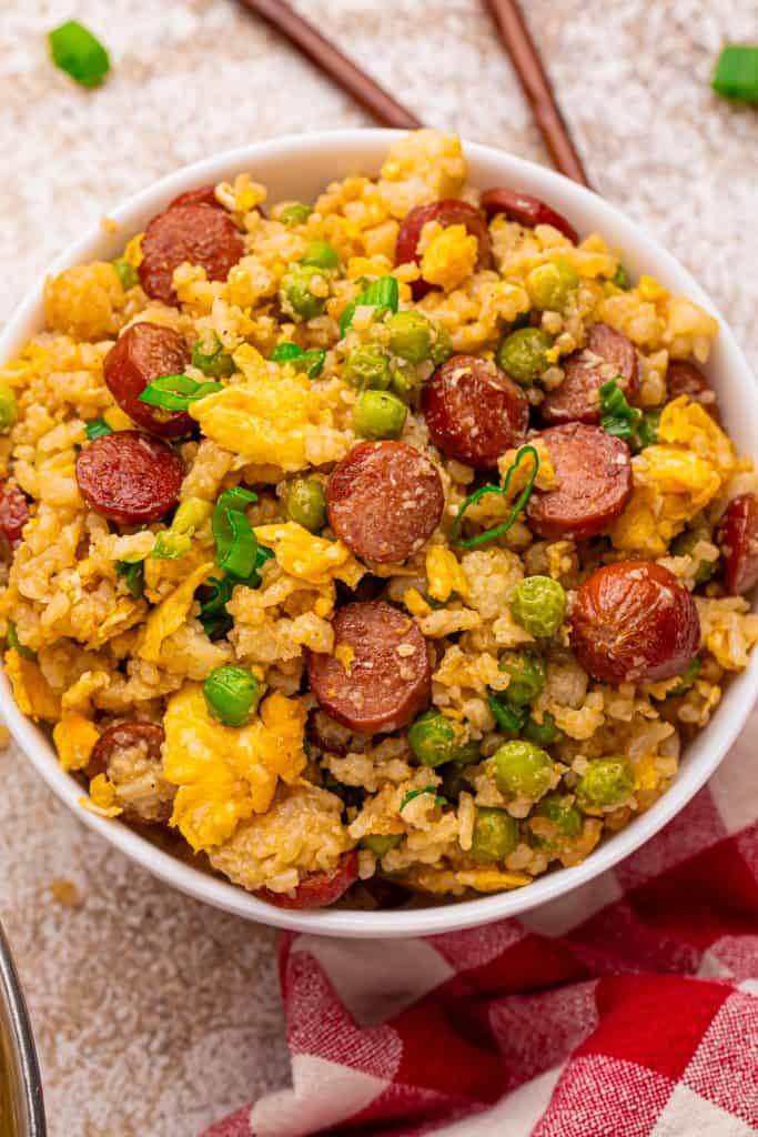 Overhead view of fried rice with hot dogs.