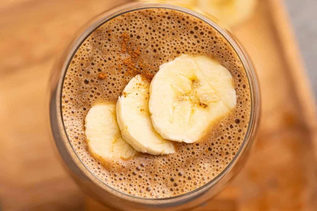 overhead view of coffee smoothie topped with banana slices