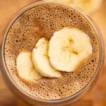 overhead view of coffee smoothie topped with banana slices
