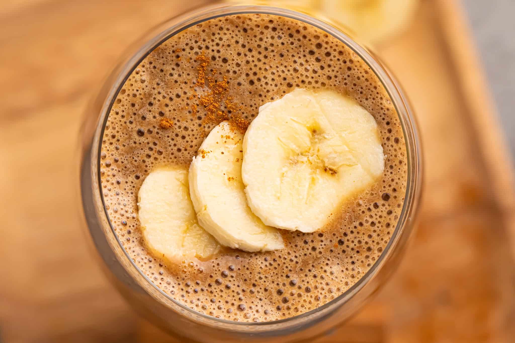 overhead view of coffee smoothie topped with banana slices