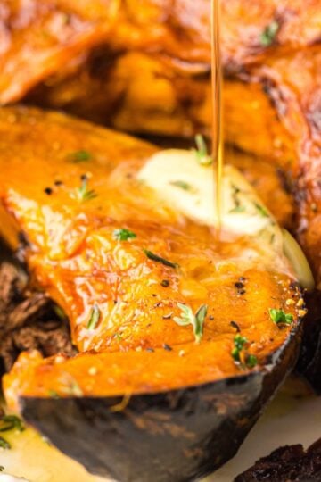 Closeup of air fryer pumpkin slices with butter and maple syrup.