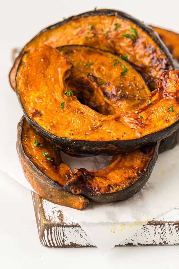 Roasted Pumpkin Slices with Maple Syrup on cutting board.
