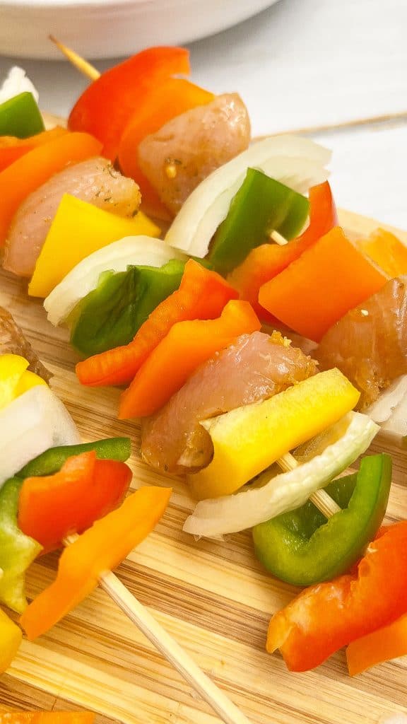 Chicken, onion and bell pepper kabobs assembled.