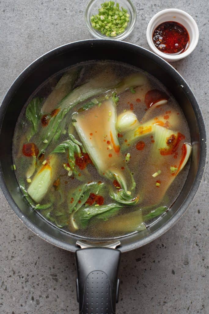 Overhead view of Bok Choy in soup broth.