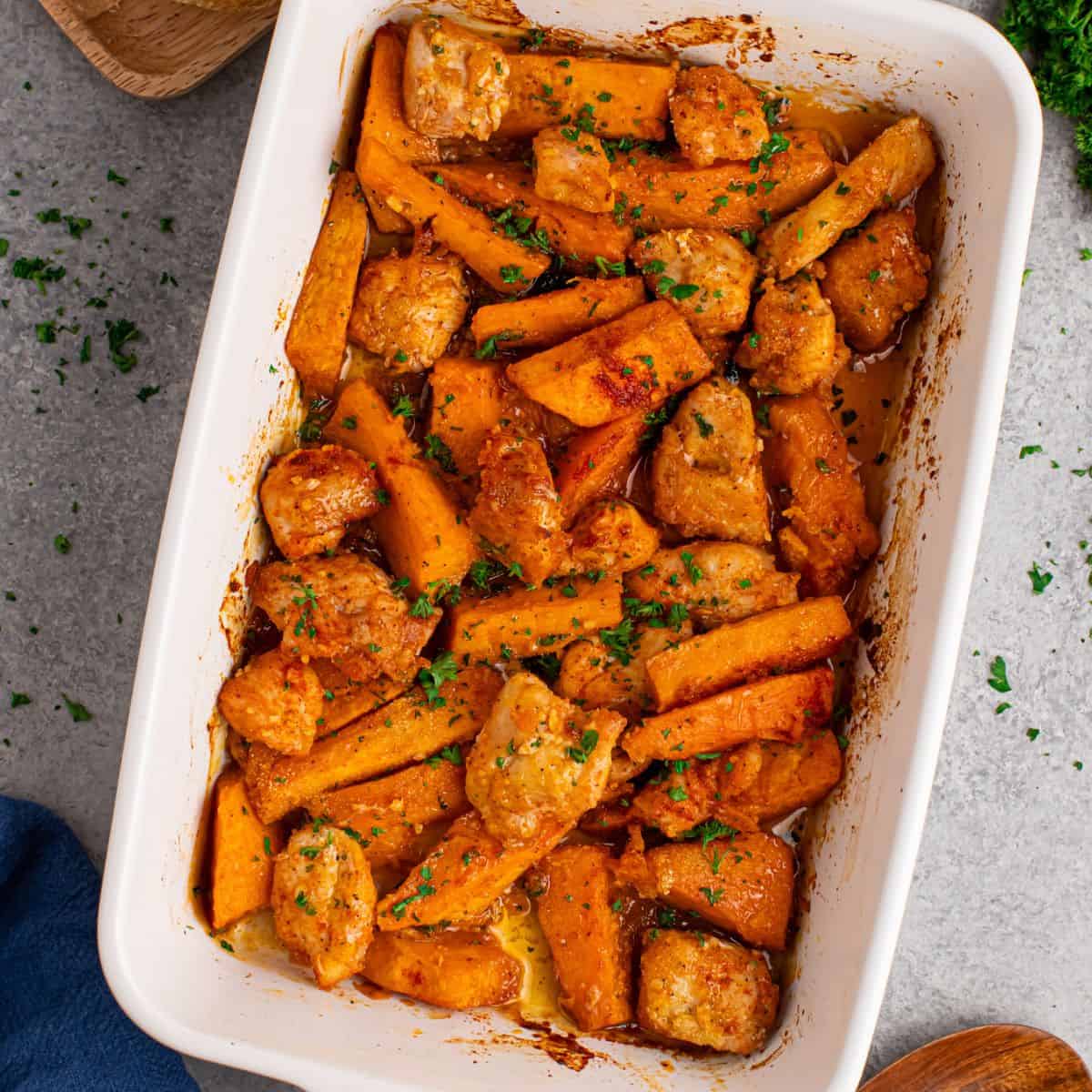 Overhead view of sweet potato chicken bake in a white casserole dish.