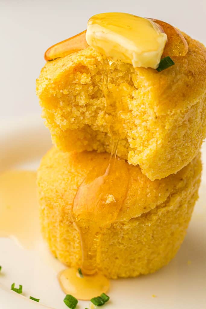 Air Fryer Cornbread Muffins stacked on top of each other.