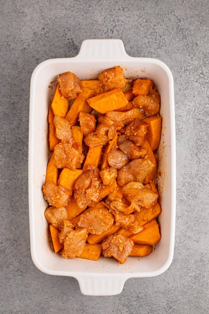 Chicken and Sweet Potato Casserole in white casserole dish ready to go in the oven.