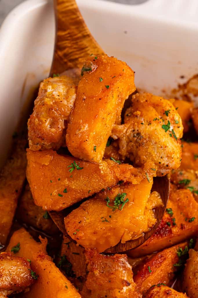 Sweet potatoes and chicken on a wood spoon.