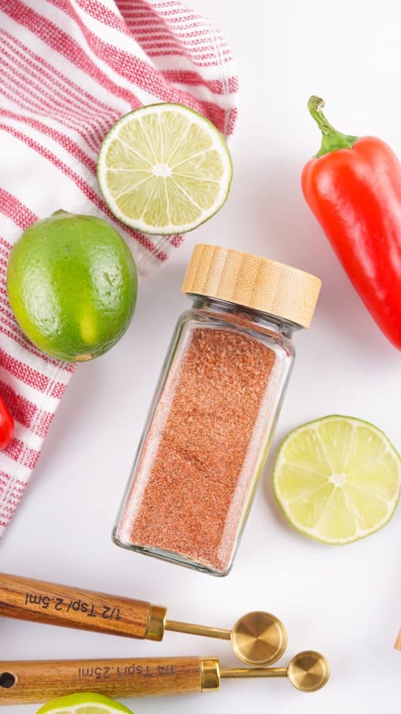 Overhead view of Tajin seasoning in a glass spice bottle