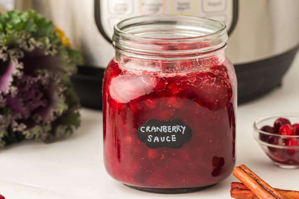 Instant Pot Cranberry sauce in glass jar.