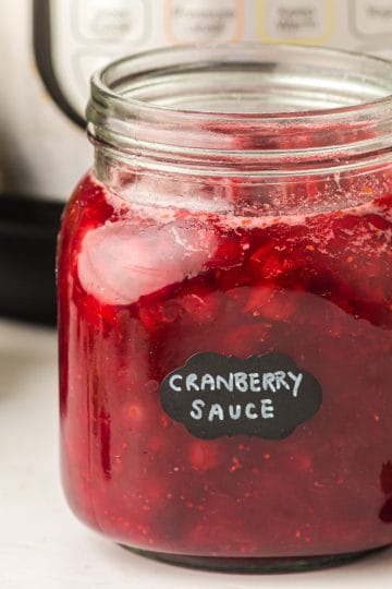 Instant Pot Cranberry sauce in glass jar.