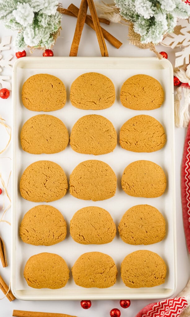 Overhead view of gingersnap cookies on a baking sheet.
