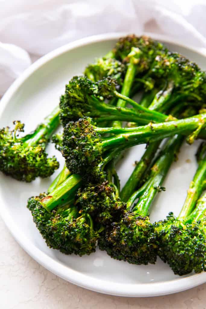 Air Fryer Broccolini on a white plat.