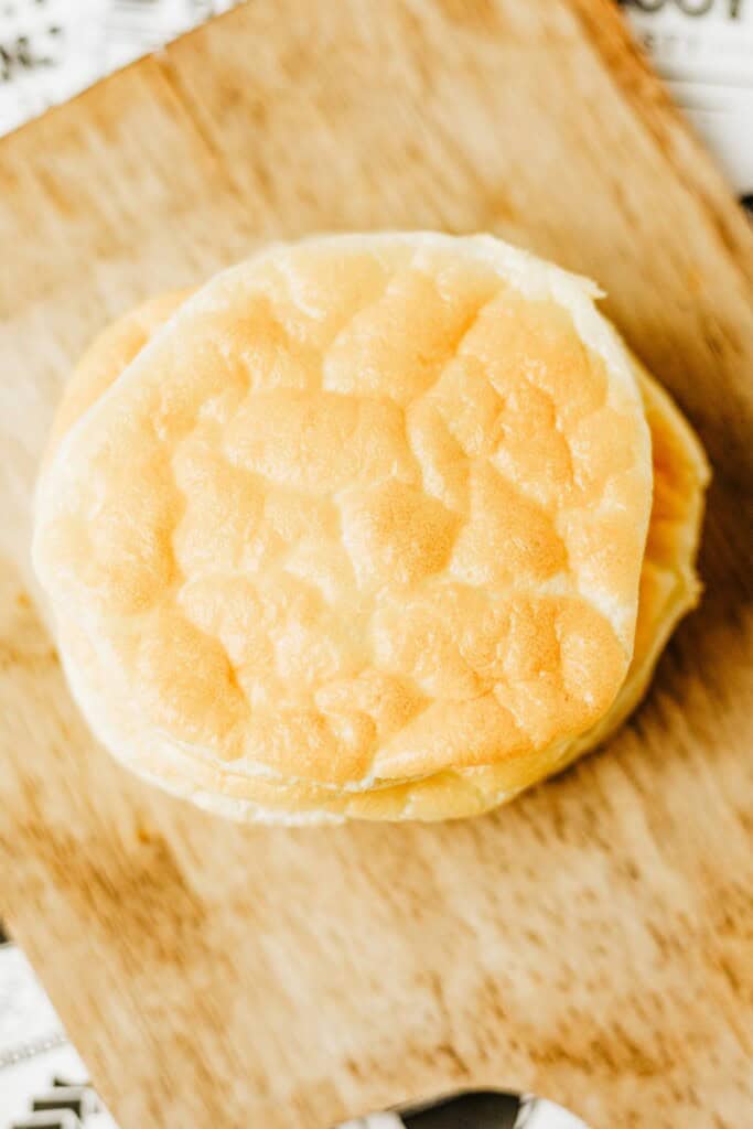 Overhead view of a stack of keto cottage cheese cloud bread on a wooden board