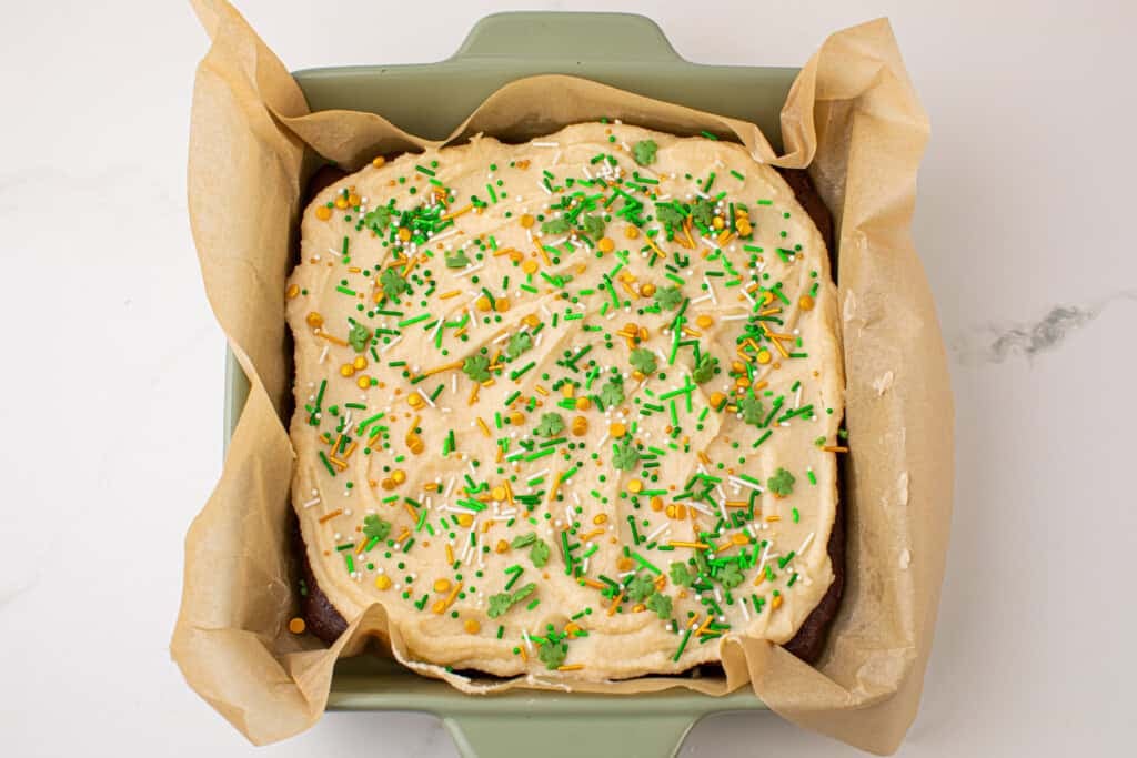 Overhead view of Guinness Brownies with Irish cream frosting with St. Patrick's day sprinkles in a baking dish.