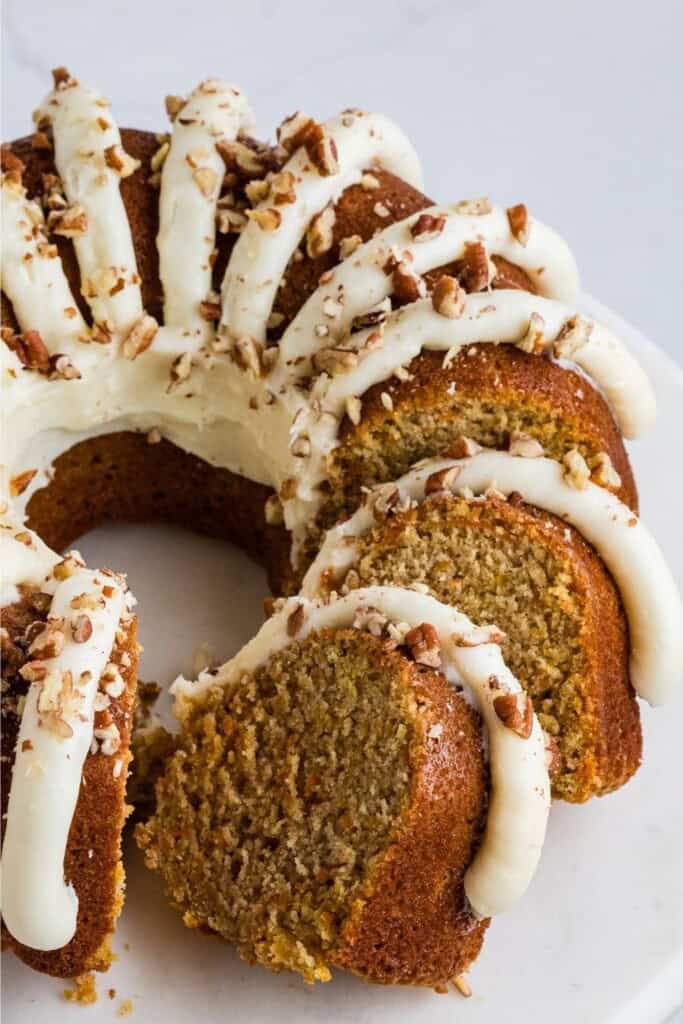 Sliced Nothing Bundt Cakes carrot cake showing moist interior with shredded carrots and chopped pecans
