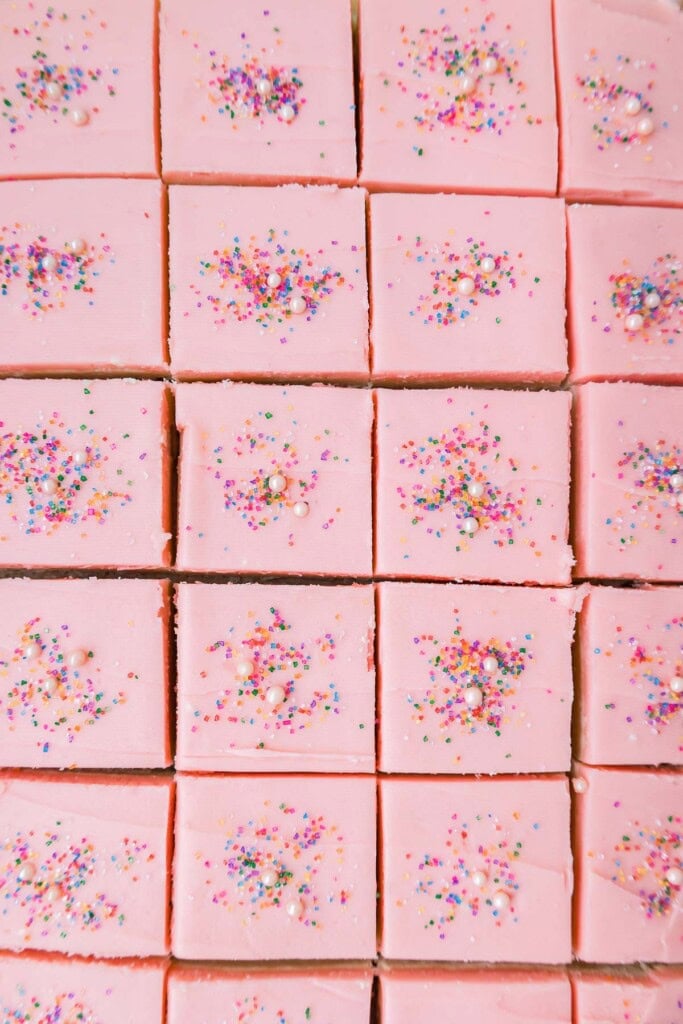 overhead view of sliced cream cheese sugar cookie bars with sprinkles.