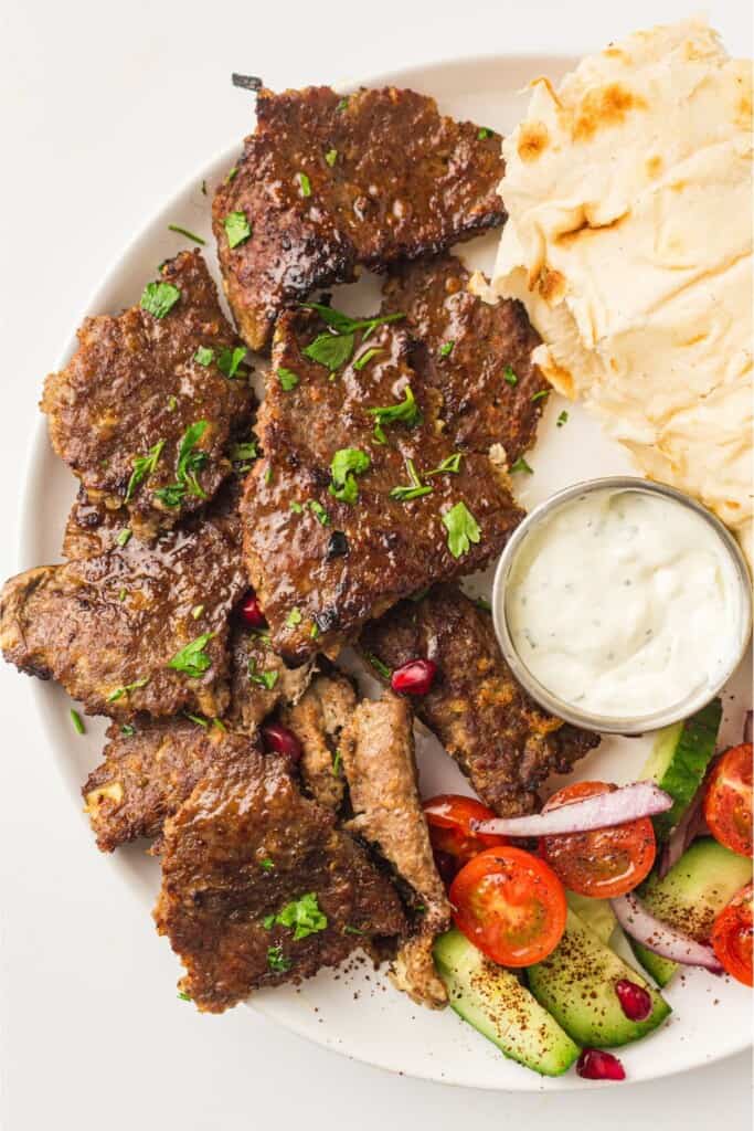homemade doner kebab plated with yogurt sauce.
