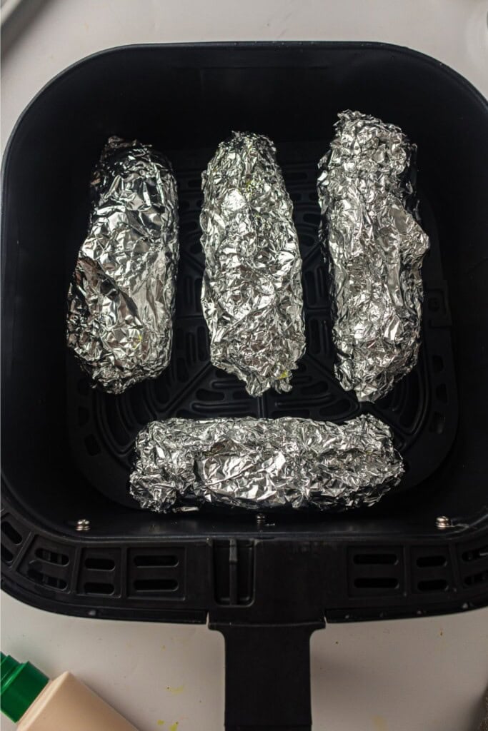 overhead view of corn wrapped in foil